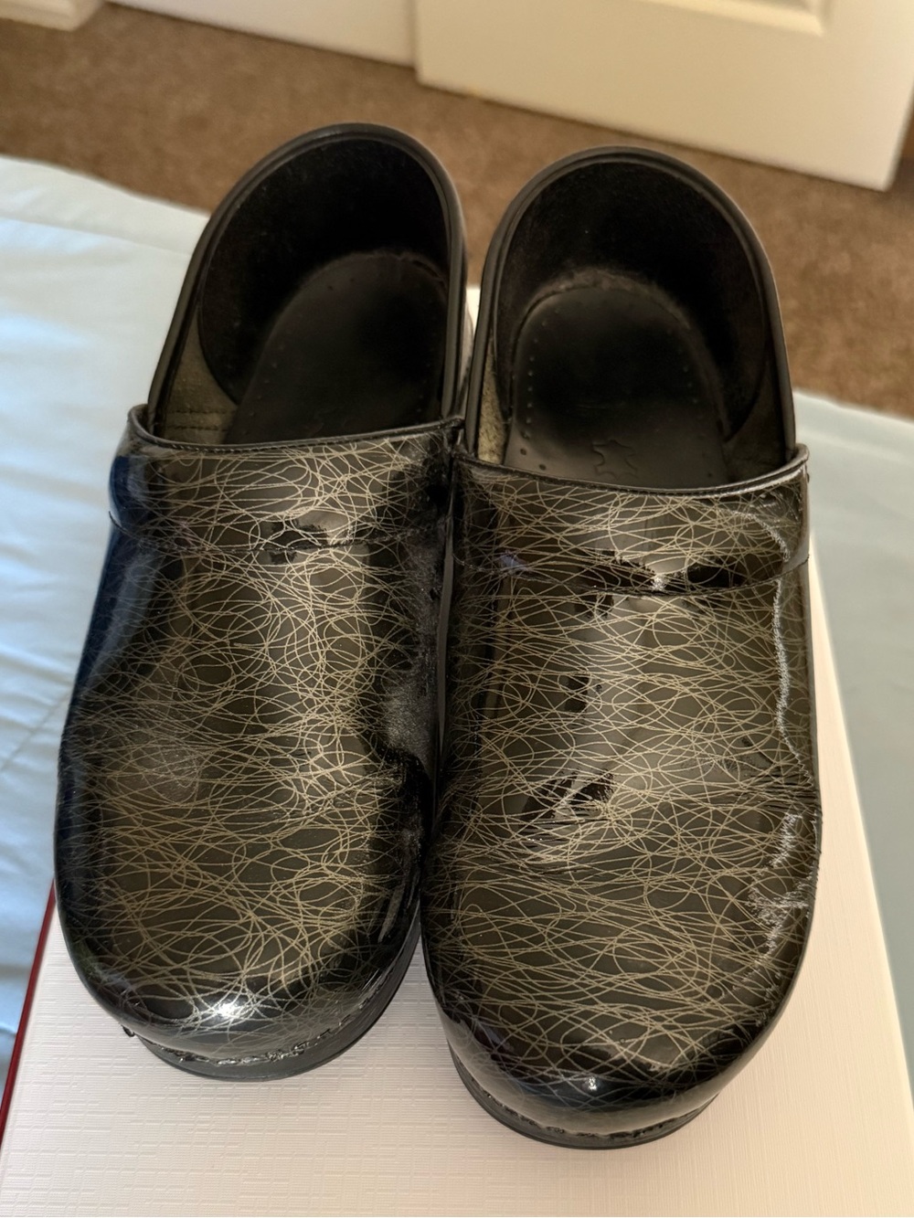 Dansko Black Patent Scribble Slip-On Clogs